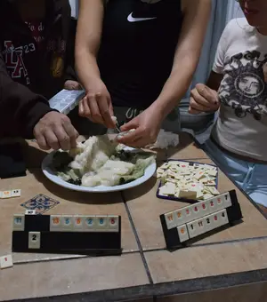 Roommates cooking together at the kitchen table